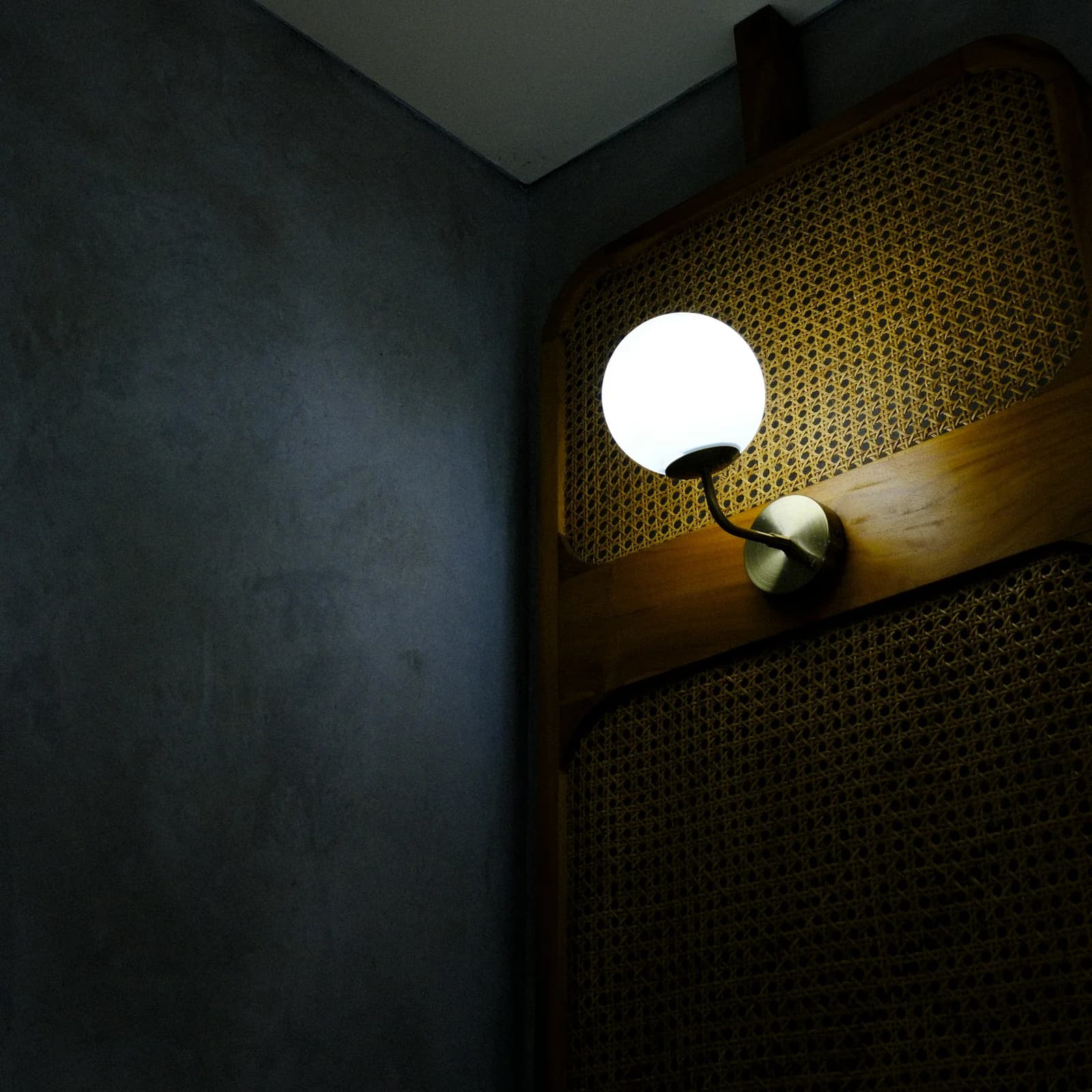 Close up of a brass wall sconce highlighting the best designer lighting brands.