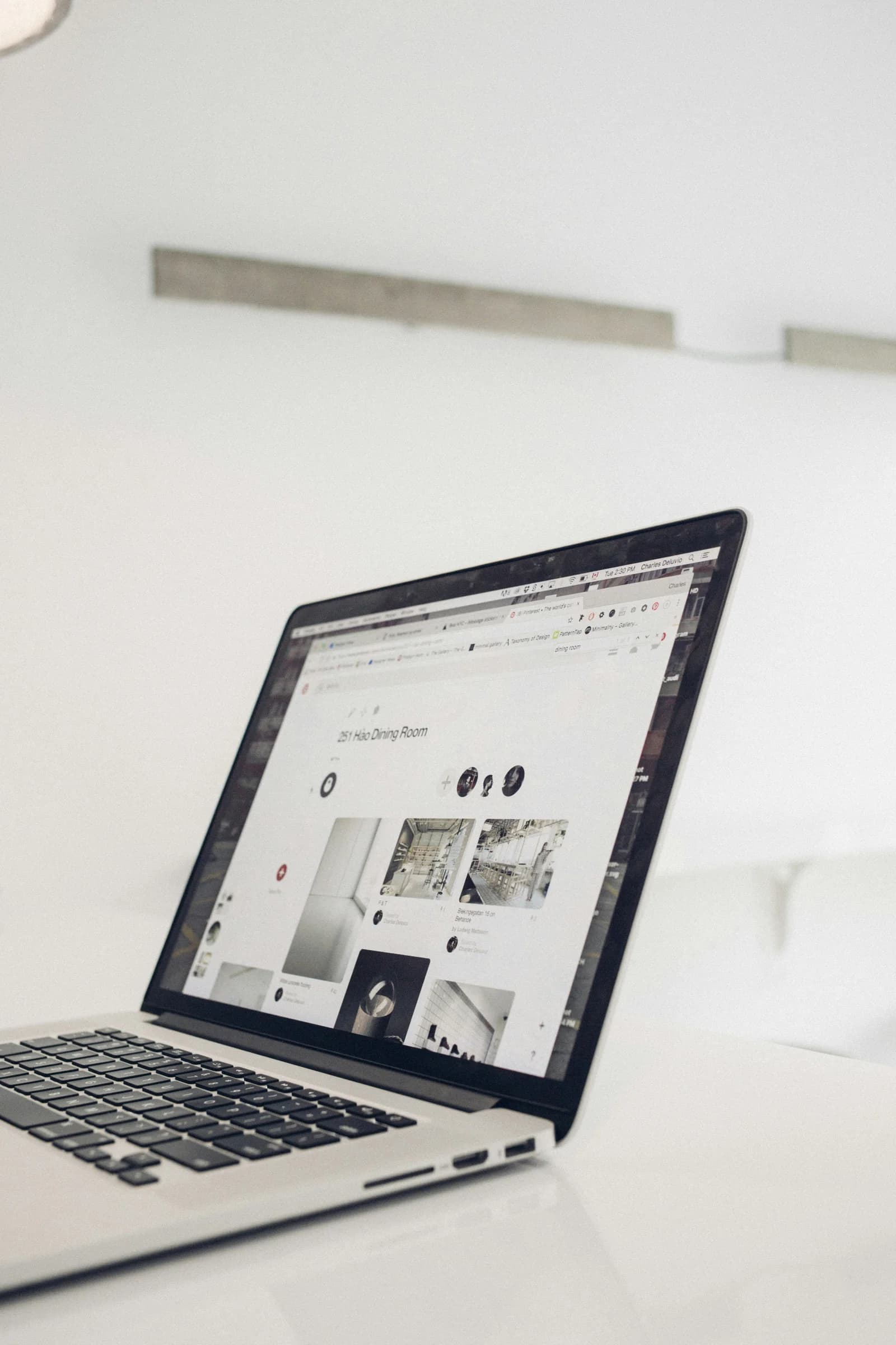 A designer using product sourcing software for interior designers on a laptop.